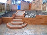 Patio, steps and pathway in bullmose, tumble blocks, and engineering bricks.